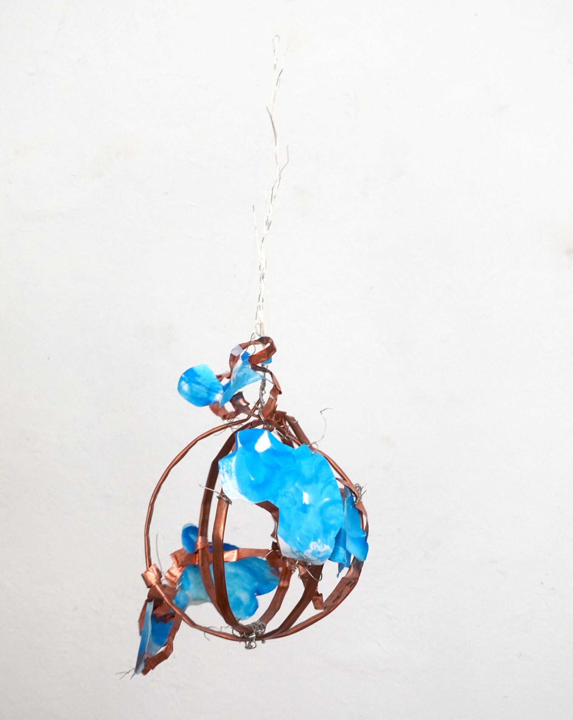 Copper-colored bands act like veins, connecting and holding, while blue, cloud-like forms are light, fleeting, and alive. Little Spirit is a poetic visualization of the interplay between energy, body, and mind — a small, floating cosmos.